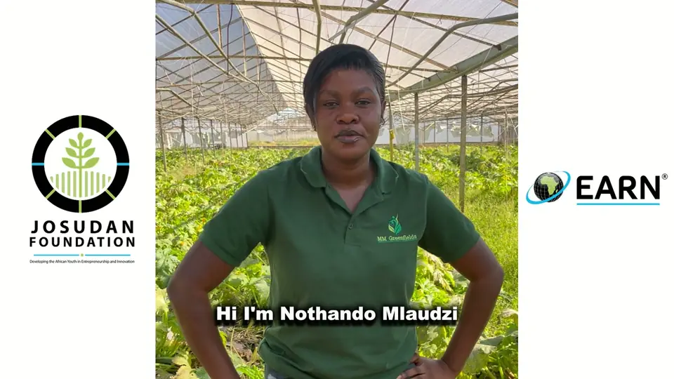 A 2024 graduate in a green shirt speaking in a growing tunnel, framed by the Josudan Foundation and EARN logos