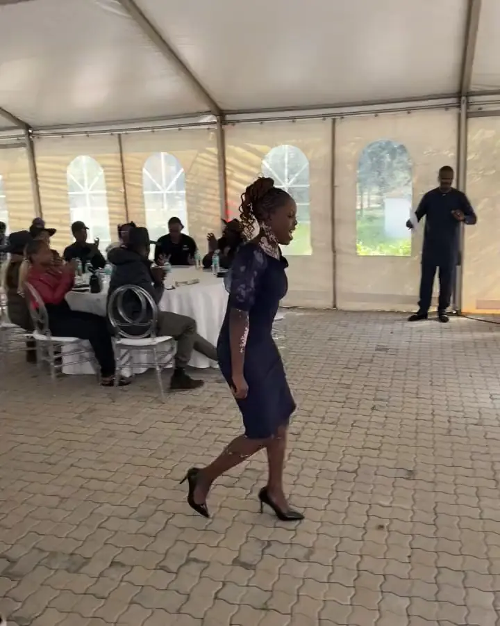 A young woman walking up to receive her certificate at the EARN graduation ceremony