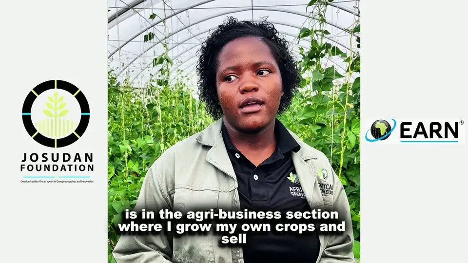 A graduating agripreneur speaking in a growing tunnel, framed by the Josudan Foundation and EARN logos